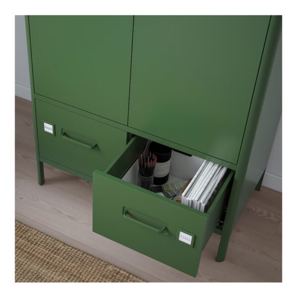 Green cabinet with open drawer showing files and magazines.