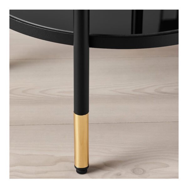 Black and gold table leg on wood floor