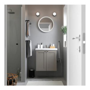 a bathroom with a sink, mirror and shower stall