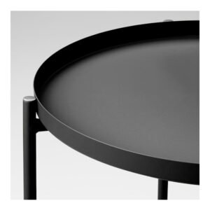 Modern black metal side table close-up view.